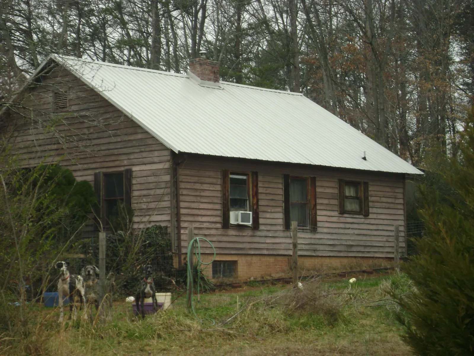 White metal roof on an old wood sided farmhouse, from a Metal Roof Installation job in Pompton Lakes